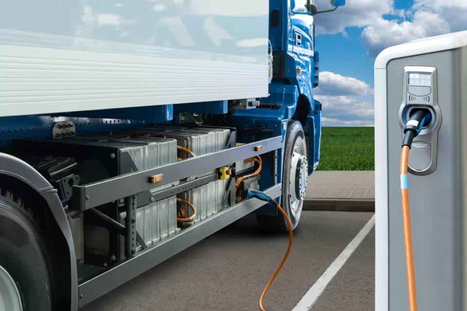Electric big rig truck plugged into charging station